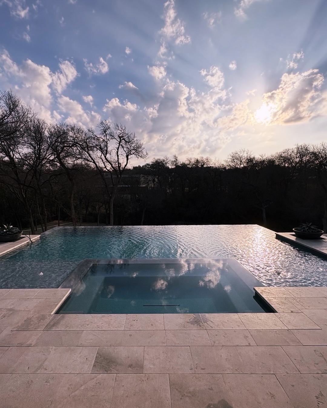 Dallas, Tx Negative Edge Pool and spa on Bachman Creek with blue pebble plaster and color LED lights