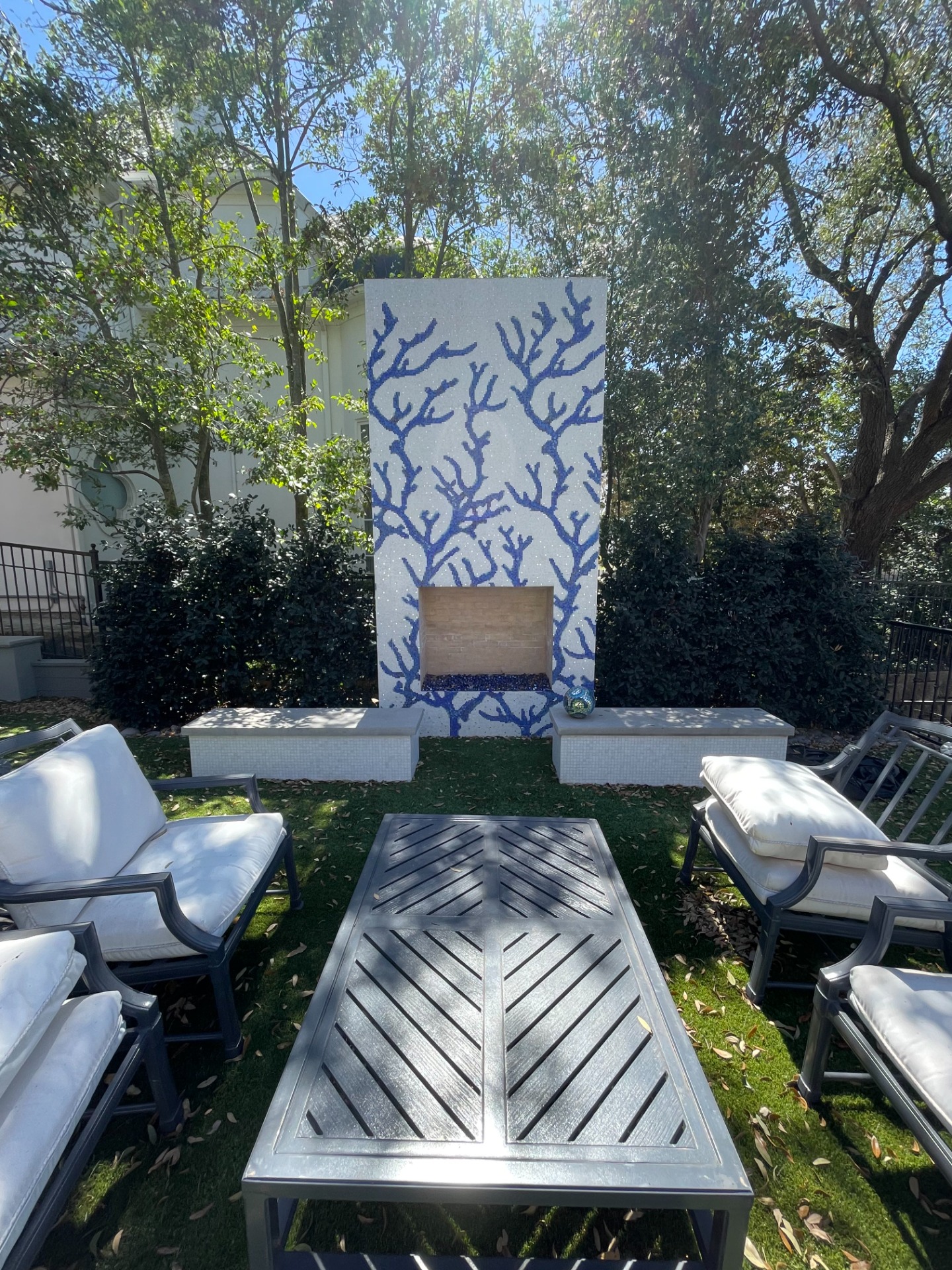 Custom Bisazza mosaic fireplace with white, blue, and white gold tiles.
