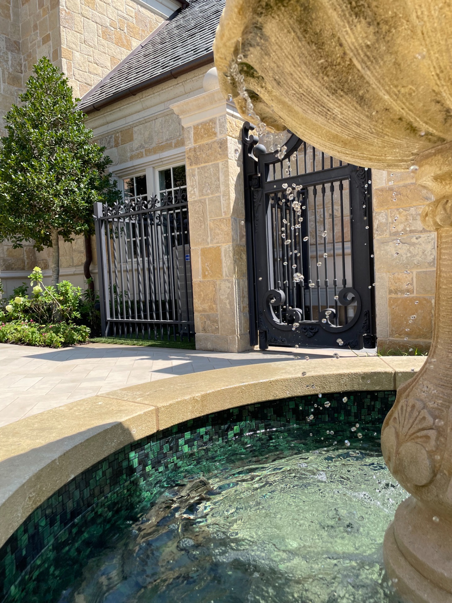 Custom Carved Stone Courtyard Fountain with custom Bisazza mosaic tile blend